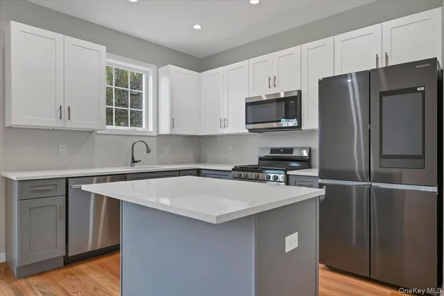 a kitchen with appliances a sink and a counter top space