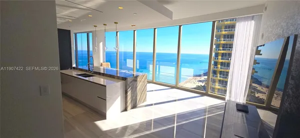 a kitchen with stainless steel appliances granite countertop a sink and a refrigerator