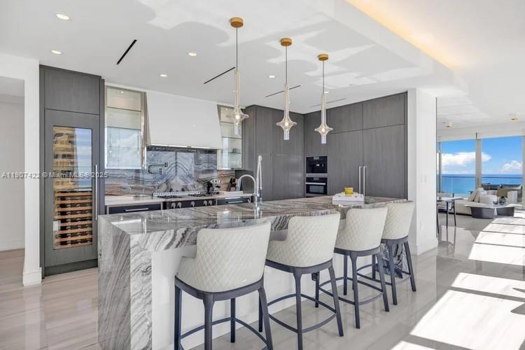 17901 Collins Avenue, Unit 2604 Sunny Isles Beach, FL 33160 - Photo 11 of 28 a large kitchen with a table and chairs