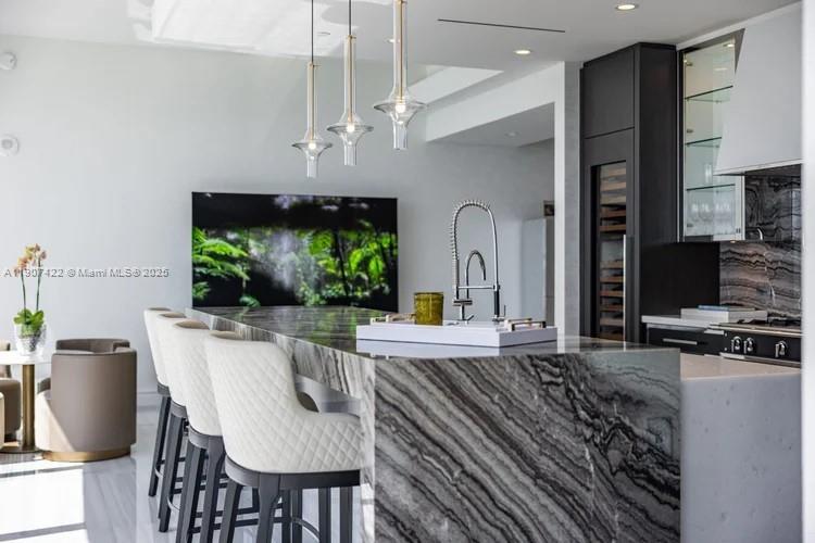 17901 Collins Avenue, Unit 2604 Sunny Isles Beach, FL 33160 - Photo 13 of 28 a living room with furniture a flat screen tv and a fireplace