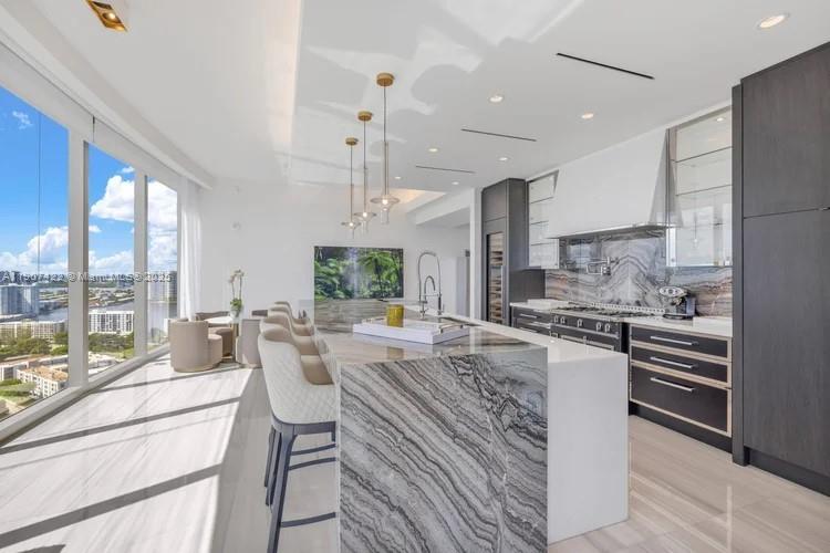 17901 Collins Avenue, Unit 2604 Sunny Isles Beach, FL 33160 - Photo 14 of 28 a large kitchen with a large window and stainless steel appliances