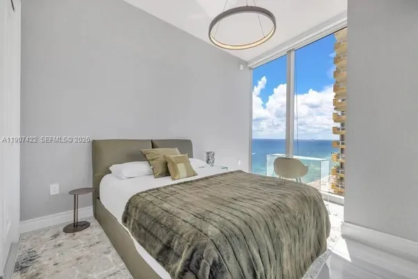 a bedroom with a bed and a chair