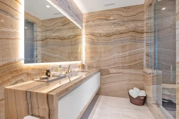 a bathroom with a granite countertop sink and a mirror