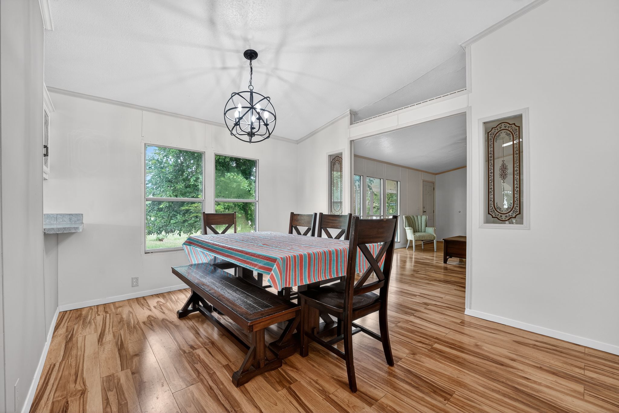 1192 County Road 225 Bluffton, TX 78607 - Photo 13 of 38 Dining area featuring wood-finish flooring and a contemporary spherical chandelier
