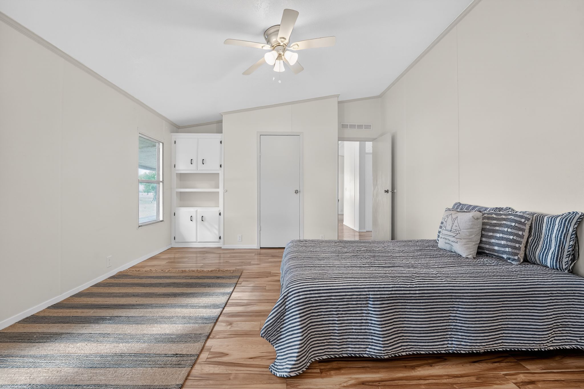 1192 County Road 225 Bluffton, TX 78607 - Photo 15 of 38 Spacious room featuring wood-finish flooring, a ceiling fan, and white walls