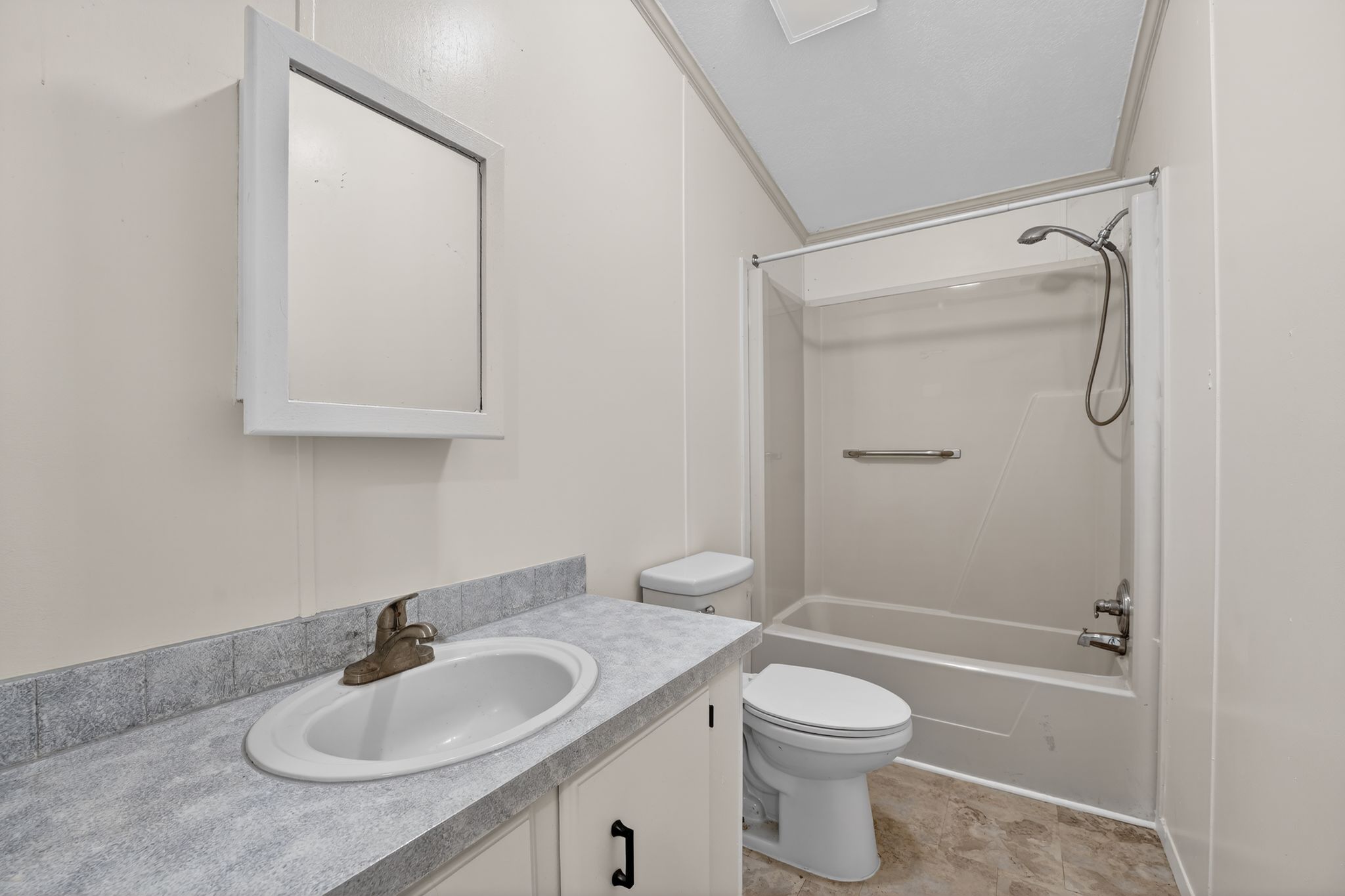1192 County Road 225 Bluffton, TX 78607 - Photo 21 of 38 Bathroom featuring a single vanity with a laminate countertop, built-in medicine cabinet, white toilet, and a combined tub and shower unit