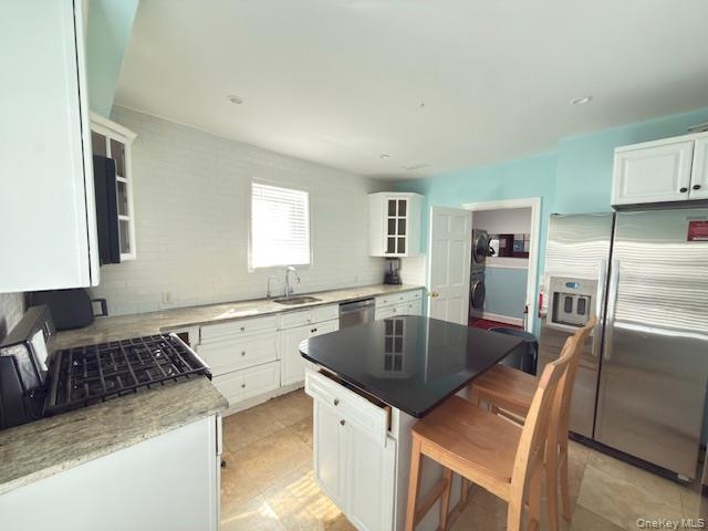 48 Church Street Patchogue, NY 11772 - Photo 15 of 19 a kitchen with stainless steel appliances granite countertop a sink a stove and refrigerator