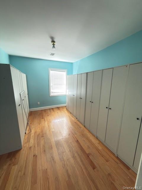 48 Church Street Patchogue, NY 11772 - Photo 17 of 19 an empty room with wooden floor and windows