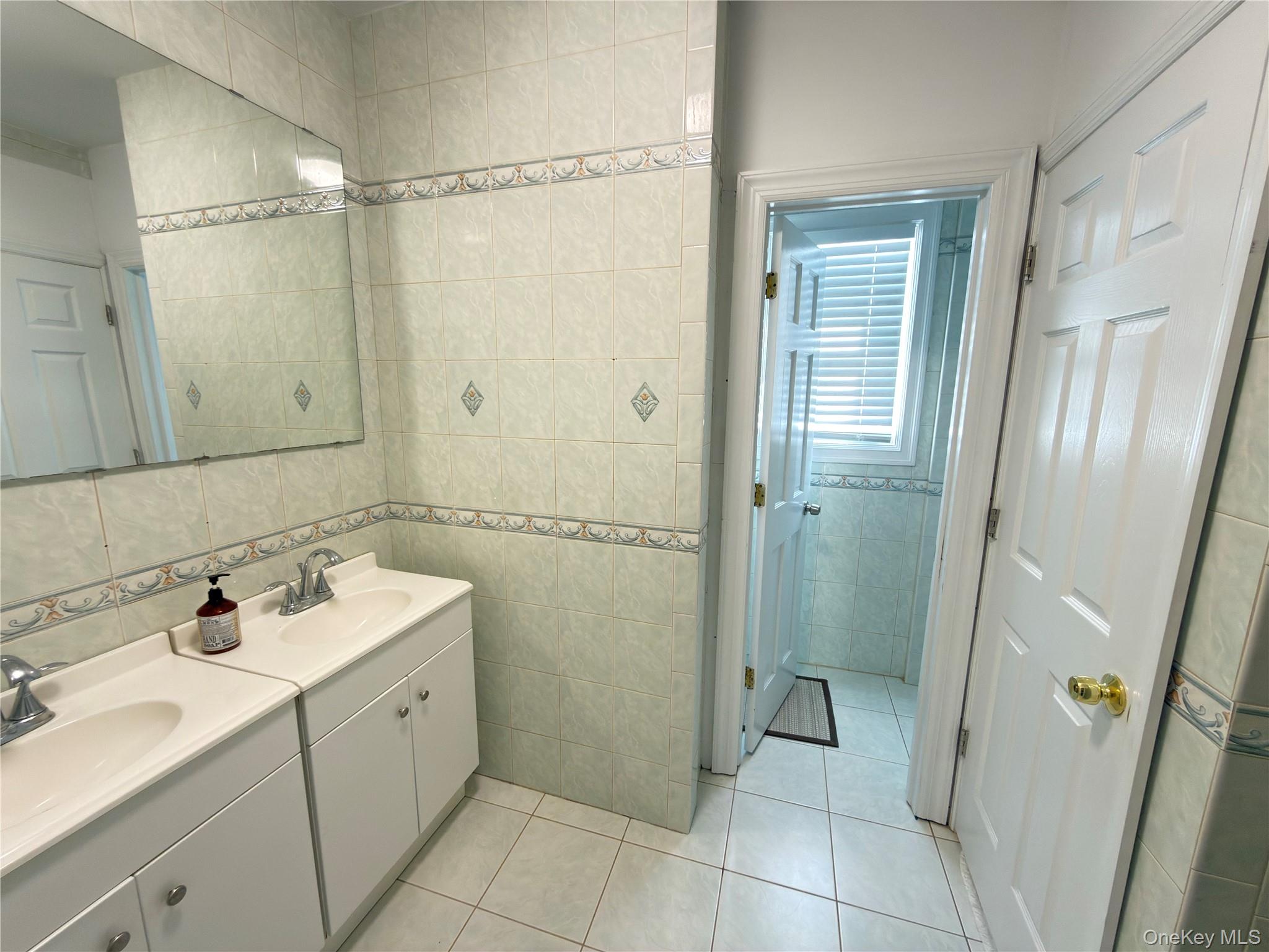 48 Church Street Patchogue, NY 11772 - Photo 9 of 19 a bathroom with a sink toilet and shower