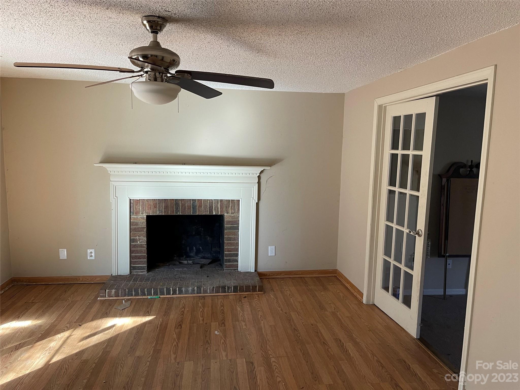 2940 Rural Hill Court Matthews, NC 28105 - Photo 9 of 24 a living room with a fireplace and a wooden floor