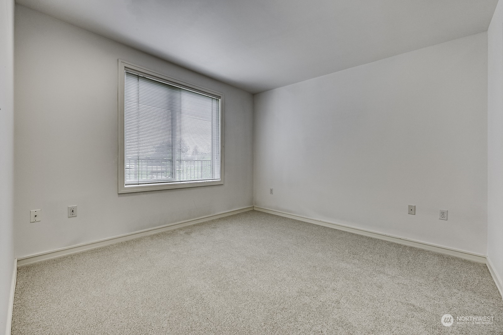 3121 West Government Way, Unit 405 Seattle, WA 98199 - Photo 15 of 29 an empty room with windows