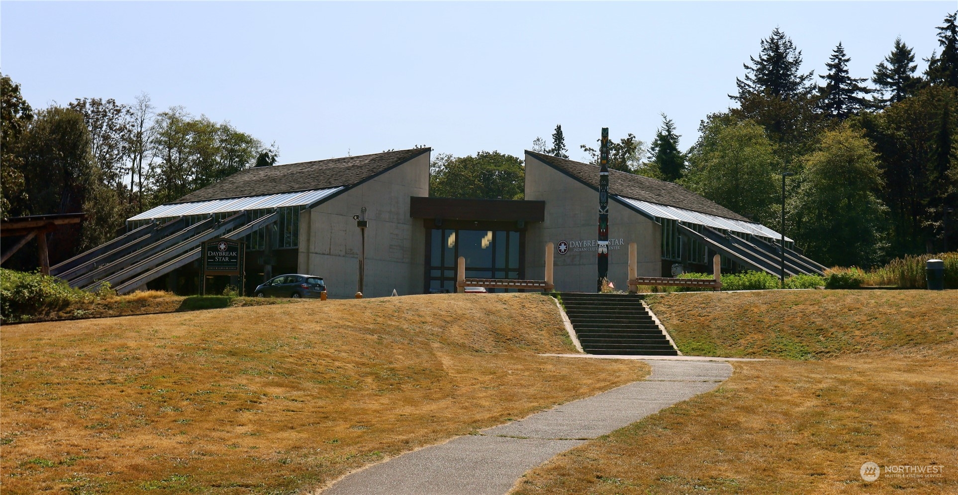 3121 West Government Way, Unit 405 Seattle, WA 98199 - Photo 28 of 29 a front view of a house with a yard and garage