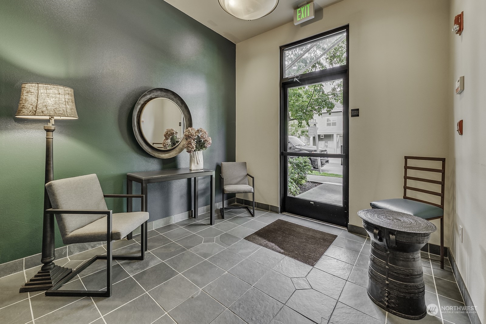 3121 West Government Way, Unit 405 Seattle, WA 98199 - Photo 3 of 29 a living room with furniture a window and a potted plant