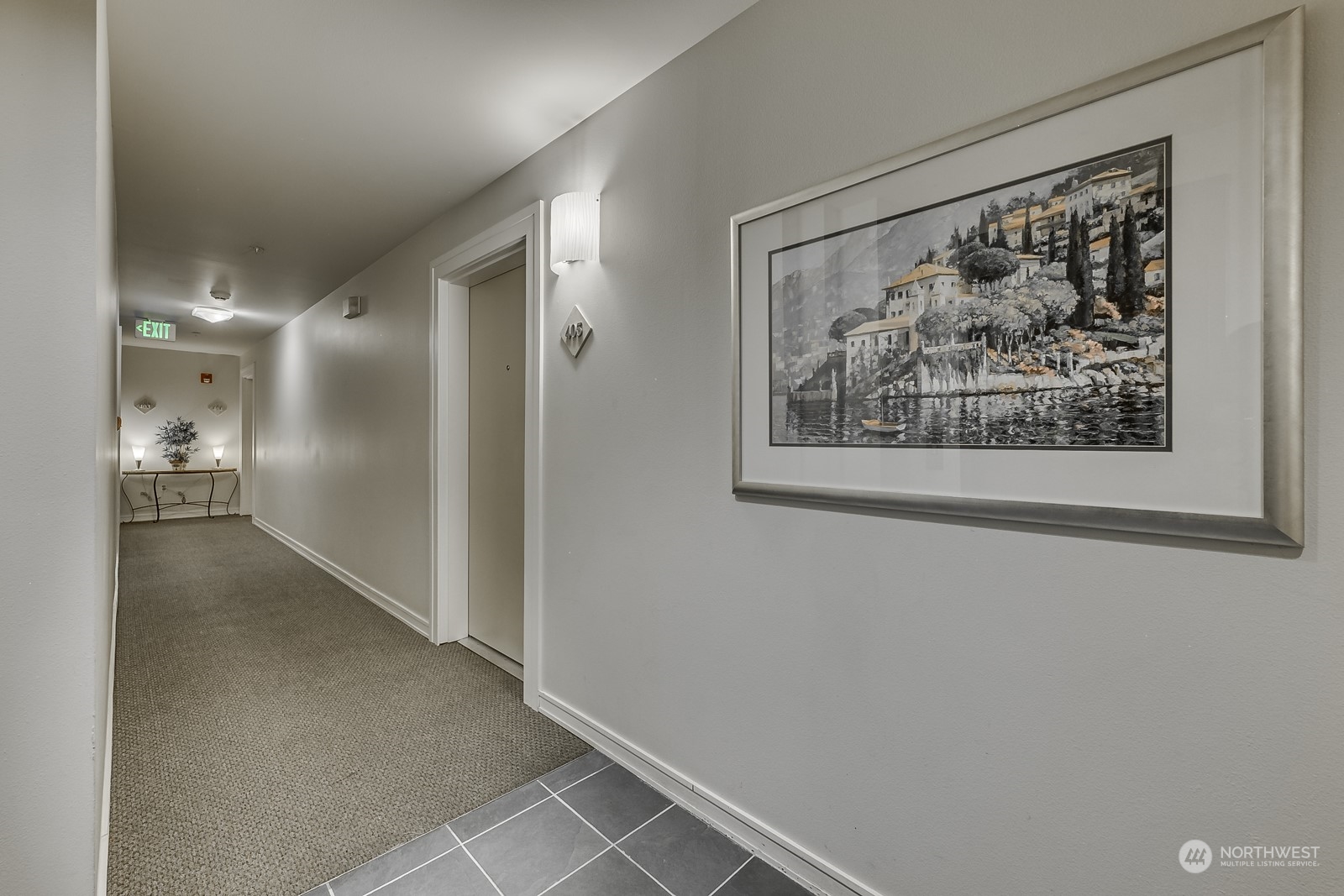 3121 West Government Way, Unit 405 Seattle, WA 98199 - Photo 4 of 29 a view of a hallway with a painting on the wall