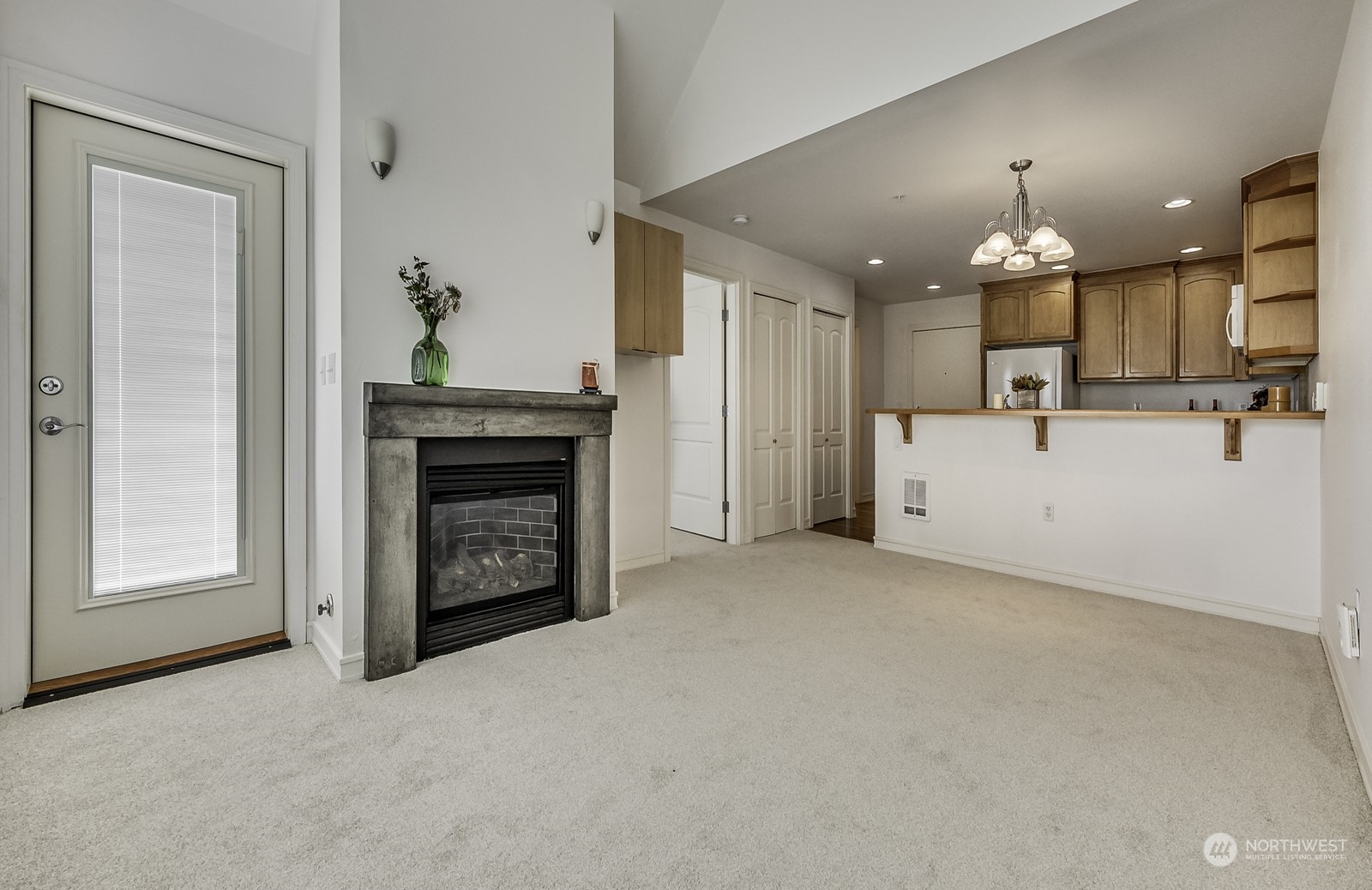 3121 West Government Way, Unit 405 Seattle, WA 98199 - Photo 5 of 29 a view of an empty room and a fireplace