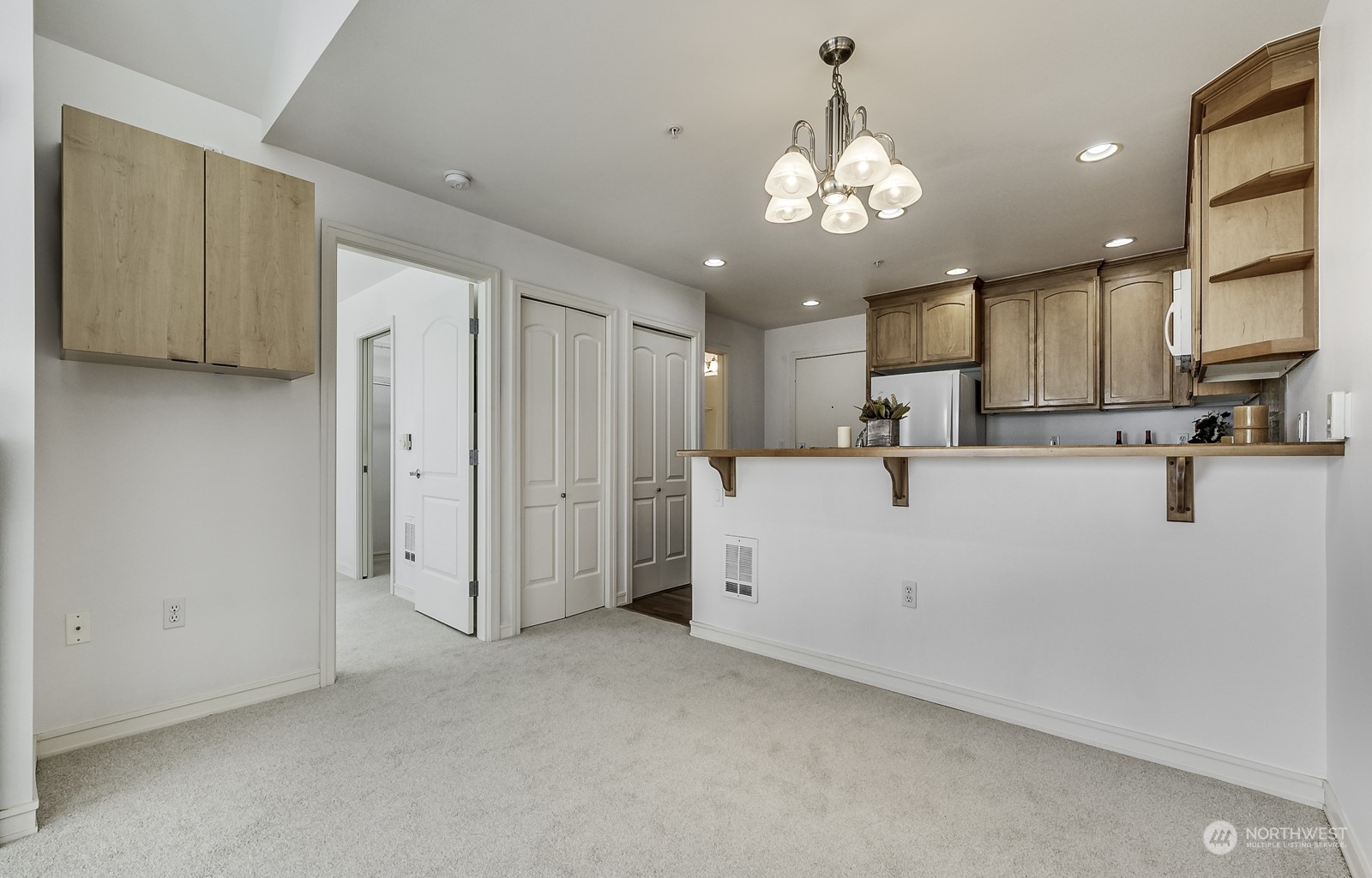 3121 West Government Way, Unit 405 Seattle, WA 98199 - Photo 7 of 29 a view of a kitchen with chandelier