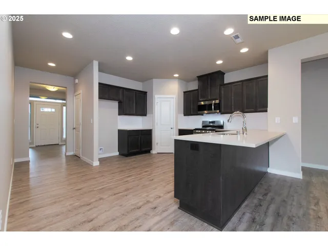 a kitchen with refrigerator cabinets and wooden floor