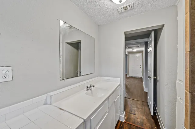 a bathroom with a sink and mirror