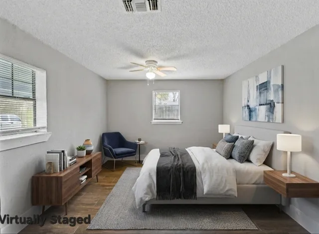 a bedroom with a bed couch and a window