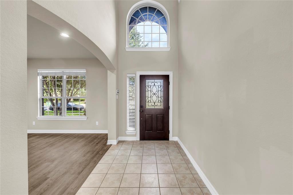1416 Rosson Road Little Elm, TX 75068 - Photo 17 of 30 Foyer featuring arched walkways, light tile patterned floors, and a towering ceiling