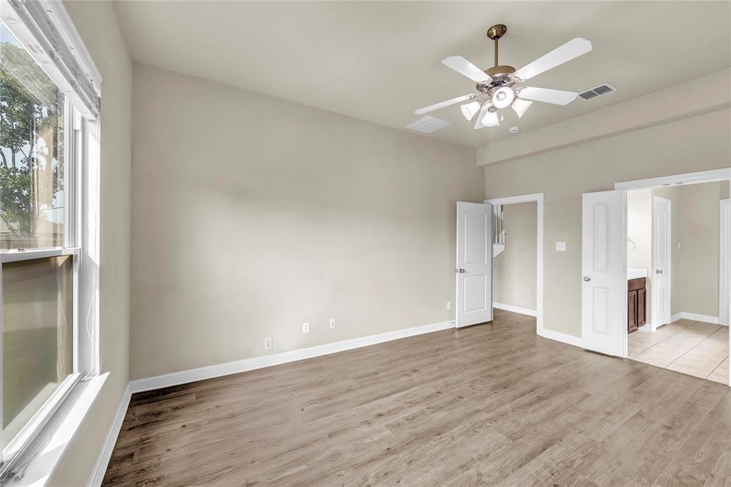 1416 Rosson Road Little Elm, TX 75068 - Photo 8 of 30 Bedroom with light wood-style floors, ceiling fan, and connected bathroom