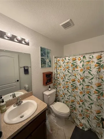 a large kitchen with cabinets and stainless steel appliances