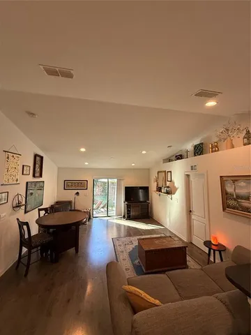 a living room with furniture and kitchen view