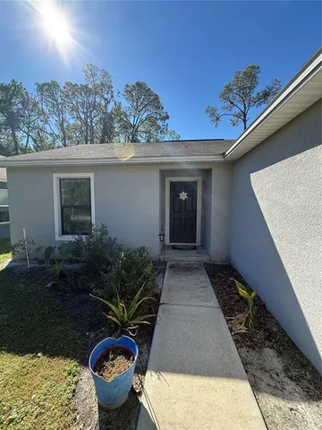 a house with a flower garden in front of it