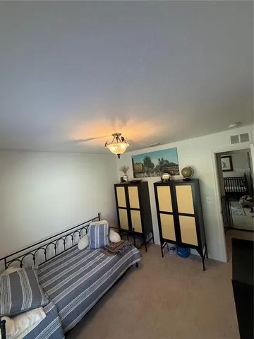 a spacious bedroom with a bed and furniture