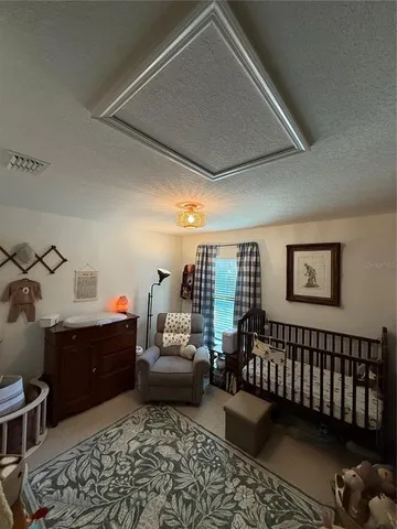 a view of a livingroom with furniture and gym equipment