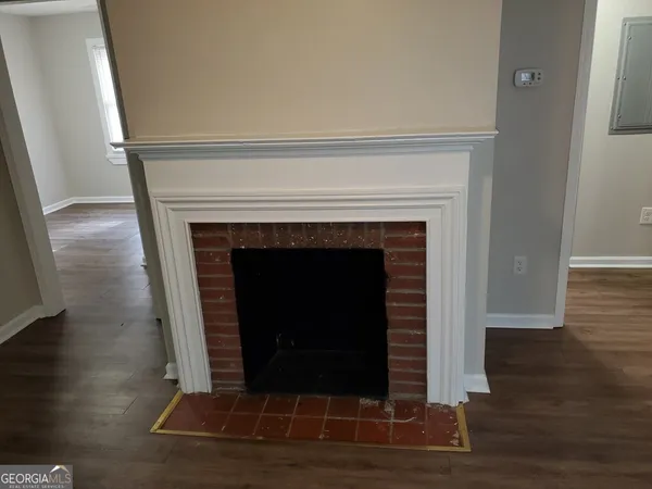 a living room with a fireplace and a wooden floor