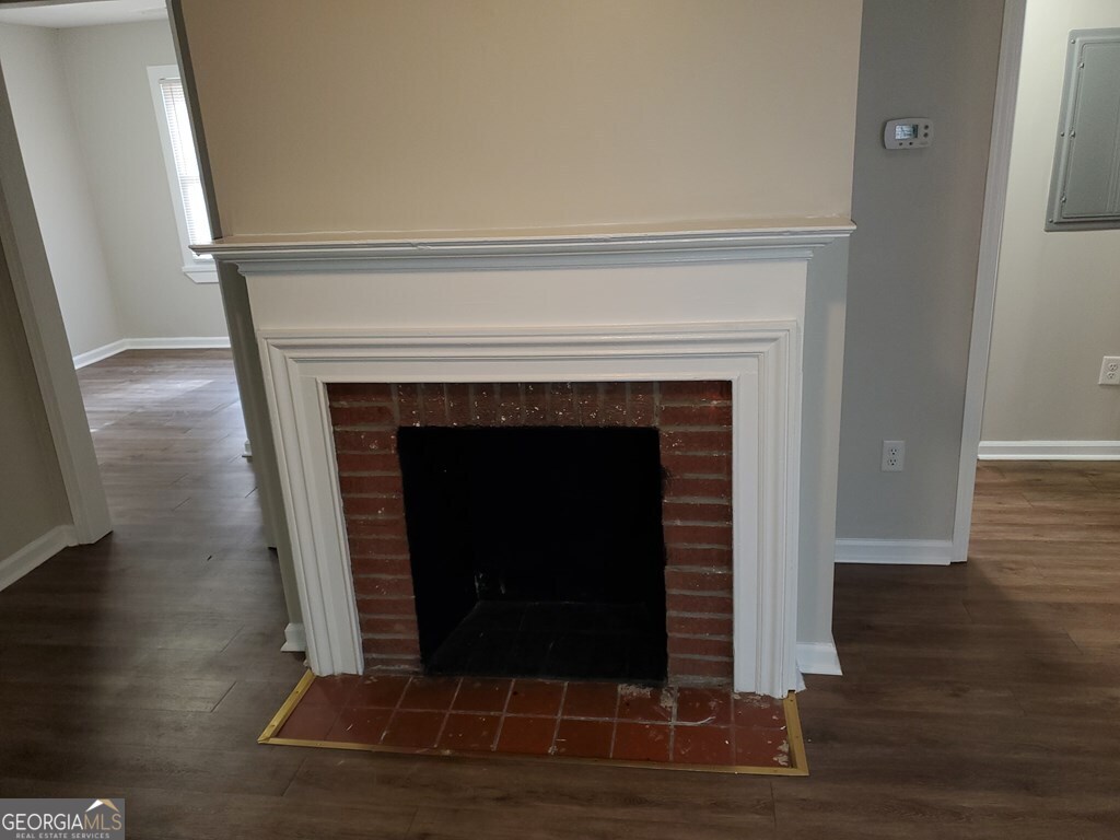 114 West Mary Street Dublin, GA 31021 - Photo 2 of 4 a living room with a fireplace and a wooden floor