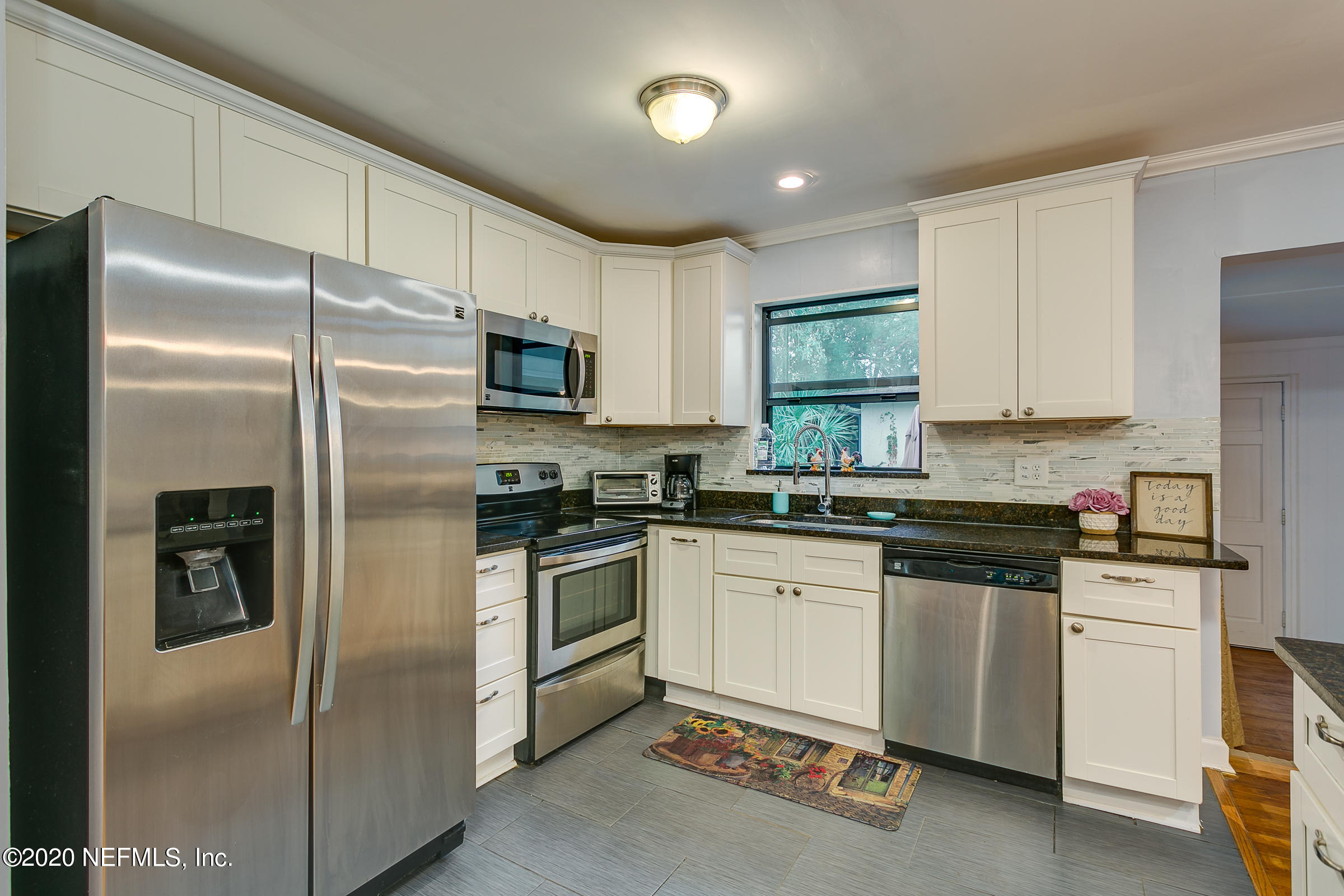 3664 Coronado Road Jacksonville, FL 32217 - Photo 8 of 28 a kitchen with granite countertop stainless steel appliances and white cabinets