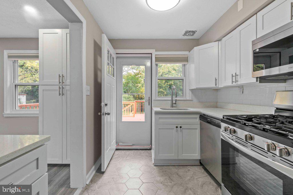 6307 Fairdel Avenue Baltimore, MD 21206 - Photo 15 of 36 a kitchen with cabinets appliances and a window