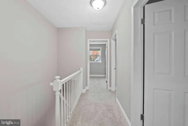a view of a hallway with wooden floor and entryway