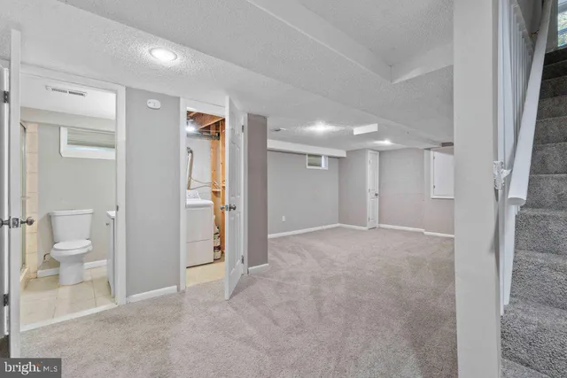 a view of a hallway with wooden shelves