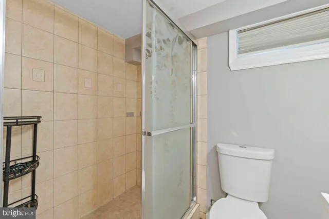 a white toilet sitting next to a bathroom sink