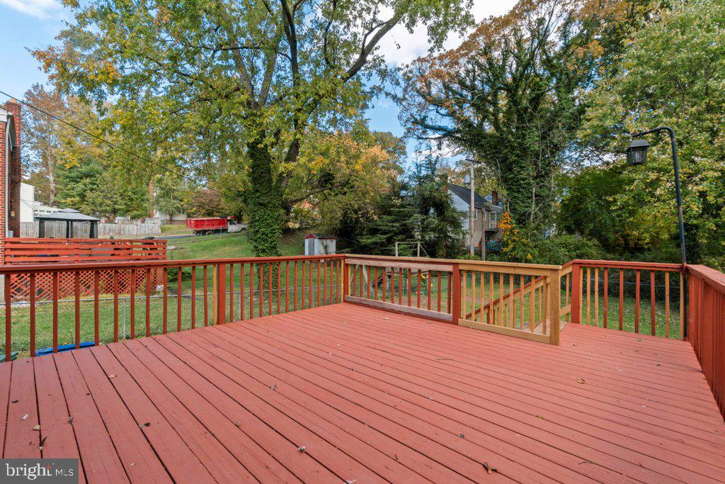 6307 Fairdel Avenue Baltimore, MD 21206 - Photo 31 of 36 a balcony with wooden floor and trees