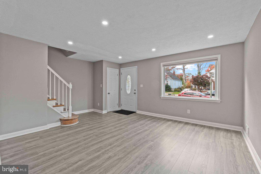 6307 Fairdel Avenue Baltimore, MD 21206 - Photo 5 of 36 an empty room with wooden floor and windows