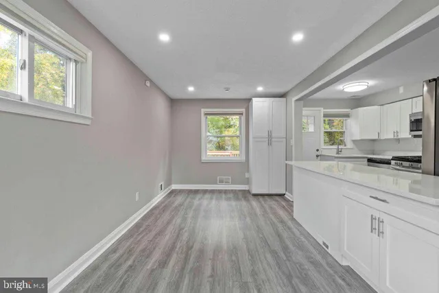 a view of kitchen with wooden floor electronic appliances and window