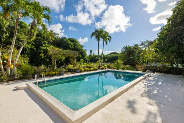 a view of swimming pool with a garden and seating area