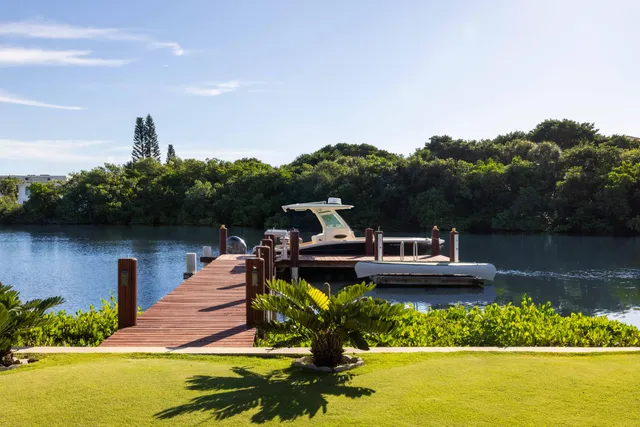 a view of a house with a yard and a garden