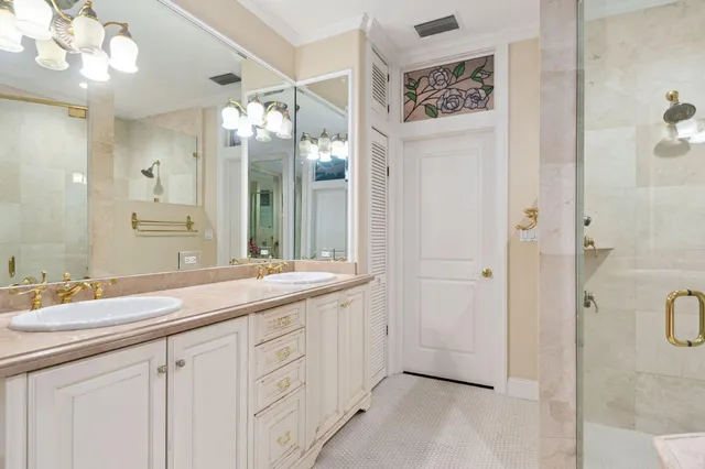 a bathroom with a double vanity sink mirror and shower
