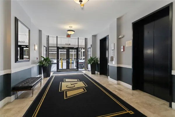 a large living room with a bed furniture and a window
