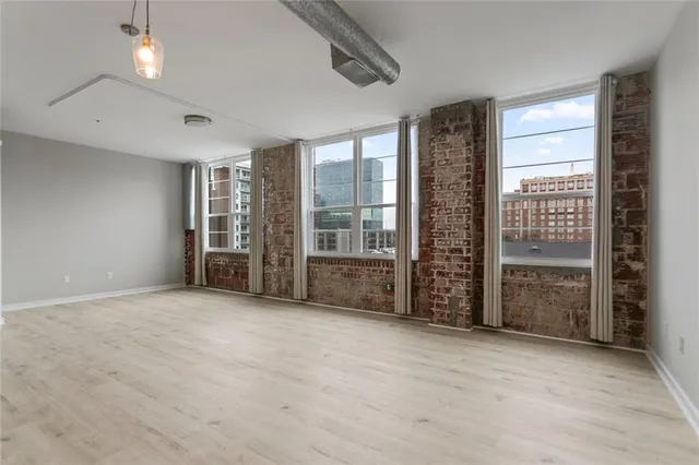 an empty room with furniture and windows