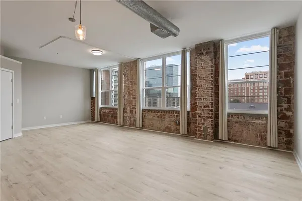 an empty room with windows closet and chandelier