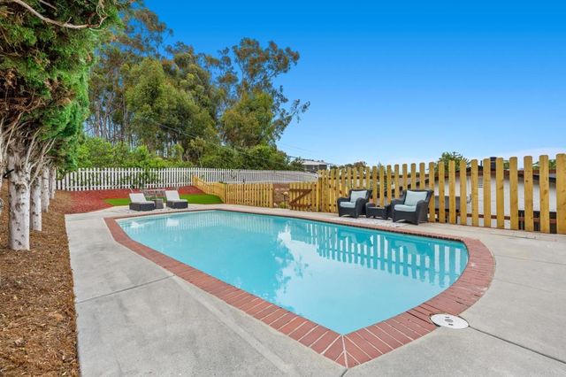 a view of a patio with couches table and chairs and potted plants