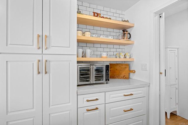 a bedroom with furniture and a large window