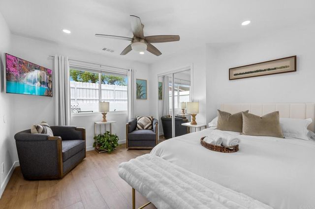 a bedroom with a bed window and a couch