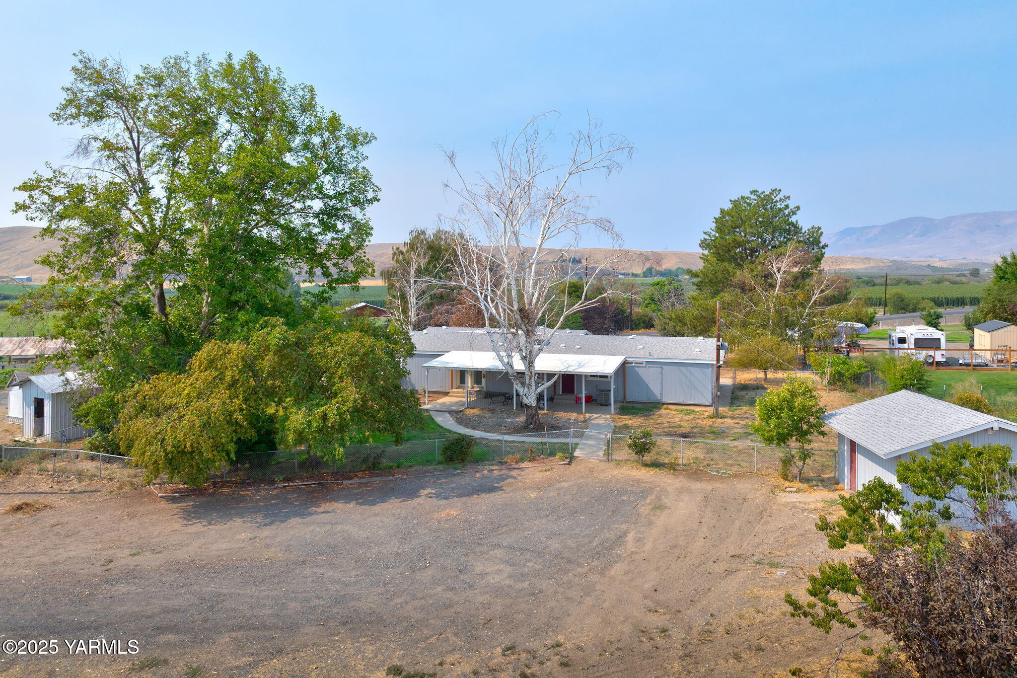 8351 North Wenas Road Selah, WA 98942 - Photo 12 of 26 a view of a house with a yard and sitting area